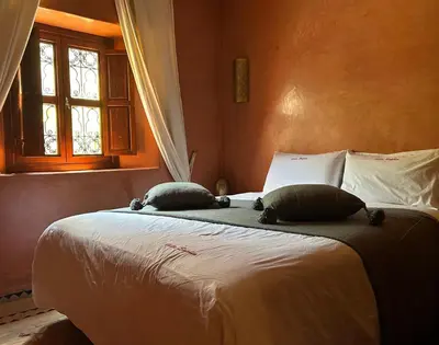 a bedroom with a bed with two pillows on it at Villa Sophia in Azib Oulad Lâdem