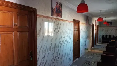 an empty hallway of a room with a wall withpainted at Hotel Nice 06 in Midelt