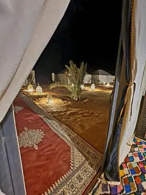a view of a tent with a red carpet and lights at Africa Luxury Camps - Merzouga Premium Camp in Merzouga