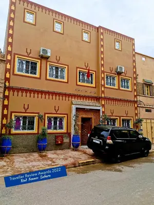 a black car parked in front of a building at Riad Fennec Sahara in Zagora