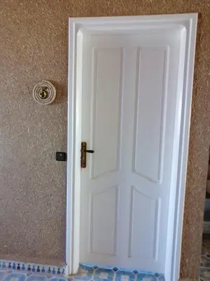 a white door in the corner of a room at Riad Fennec Sahara in Zagora