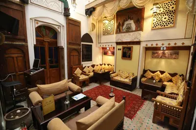 a large living room with couches and a fireplace at Dar Belmamoun in Fès