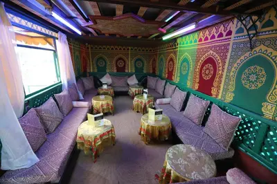a room with purple chairs and tables in a restaurant at Dar Belmamoun in Fès