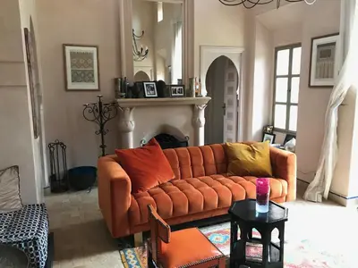 a living room with a couch and a fireplace at Villa #1 ‘Rosalie’ in Marrakech
