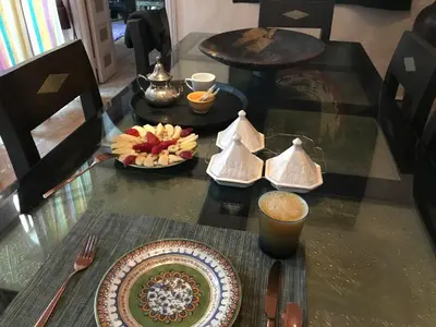 a glass table with a plate of food on it at Villa #1 ‘Rosalie’ in Marrakech