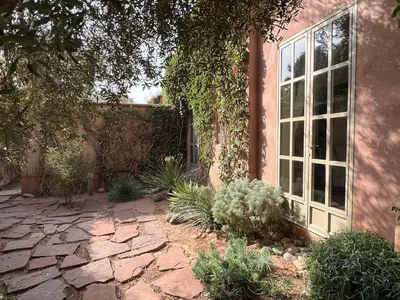a garden with a stone walkway next to a building at Villa #1 ‘Rosalie’ in Marrakech