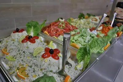 a group of trays filled with rice and vegetables at Residence Touristique Merzouga in Merzouga