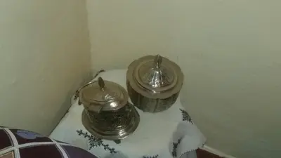 two jars sitting on a table in a room at Auberge de Tabhirte in Tahla