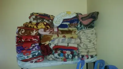 a pile of clothes sitting on a shelf at Auberge de Tabhirte in Tahla