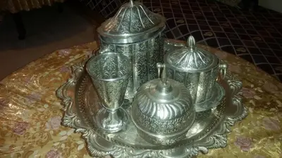 a group of silver containers on a table at Auberge de Tabhirte in Tahla