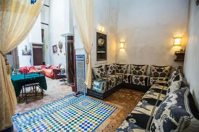 a living room with a couch and a table at Riad Zina Fes - Elegance in the Heart of Fes in Fès