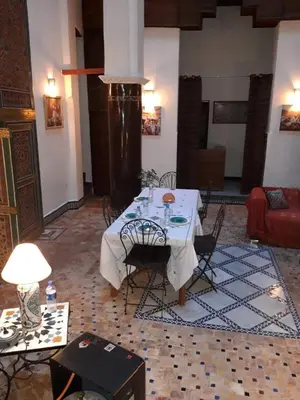 a dining room with a table and chairs in a room at Riad Zina Fes - Elegance in the Heart of Fes in Fès