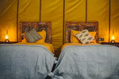 a bedroom with two beds with pillows on them at Auberge Bivouac La Belle Etoile in Merzouga