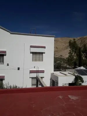 a white building with windows on the side of it at BELLE MAISON AU COEUR DES MONTAGNES DE TAZA à moins de 10 minutes de l'AGORA PARK in Taza