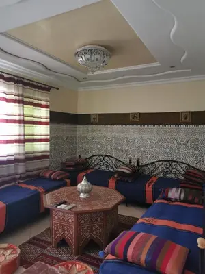 a living room with two couches and a table at Adam's House-moroccan style in Fès