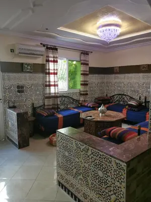 a living room with blue couches and a table at Adam's House-moroccan style in Fès