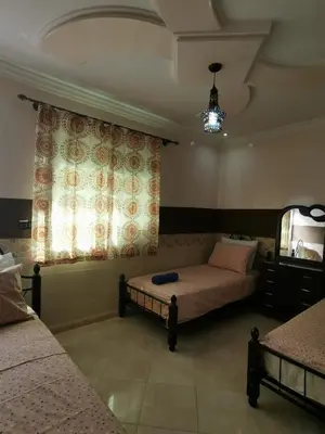 a bedroom with two beds and a window at Adam's House-moroccan style in Fès