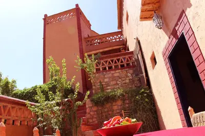 a bowl of fruit sitting on a table next to a building at Riad Gabsi Dades in Boumalne