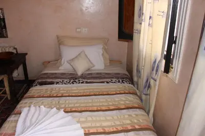a small bed in a small room with at Riad Gabsi Dades in Boumalne