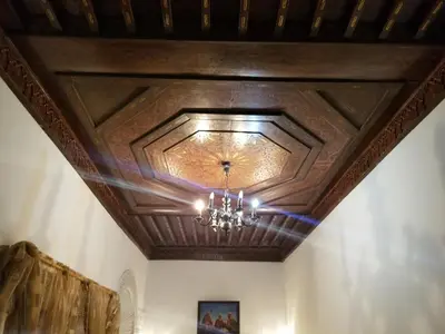 a coffered ceiling with a chandelier in a room at Riad El Bacha in Fès