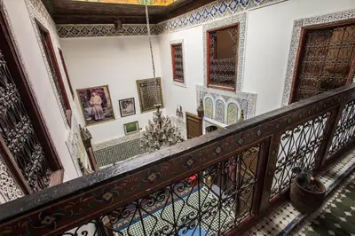 an ornate staircase in a building with a balcony at Riad El Bacha in Fès