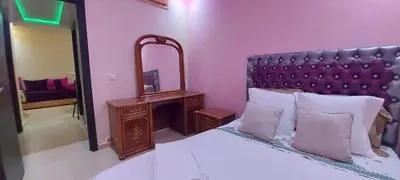 a bedroom with a large bed with a large mirror at حدائق إفران in Ifrane