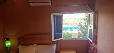 a window in a room with a bed and a bed sidx sidx sidx at Bio Palace Hotel in Tinerhir