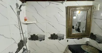 a bathroom with a mirror and a sink at Riad Le Petit Patrimoine De Fés in Fès