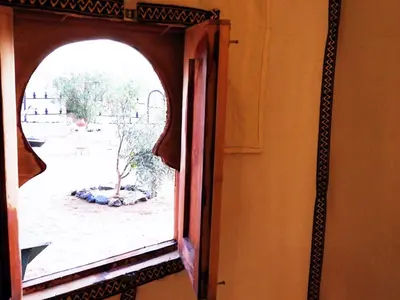 a window in a room with a view of a yard at Sleeping in a Luxury tent in Merzouga desert in Merdani
