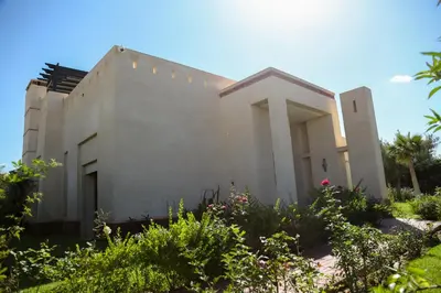 a white house with some plants in front of it at La Rose des Sables in Marrakech