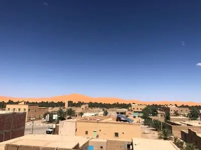 a view of a city with mountains in the background at Dar fatima merzouga in Merzouga
