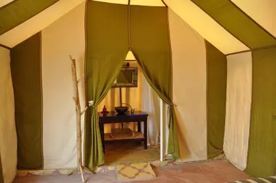 a room with a green and white tent at Dar fatima merzouga in Merzouga