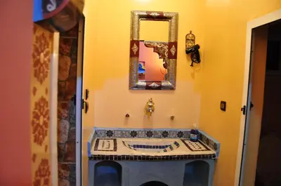 a bathroom with a sink and a mirror on the wall at Dar fatima merzouga in Merzouga