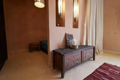 a living room with a table with a candle on it at Kasbah Flilou in Aït Ougliff