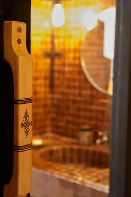 a close up of a window with a cross in the background at Kasbah Flilou in Aït Ougliff