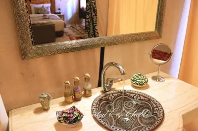 a bathroom counter with a sink and a mirror at Luxury Tented Erg Chebbi in Merzouga