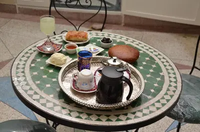a table with a plate of food and drinks on it at Gite El Menzeh in Moulay Idriss Zerhoun