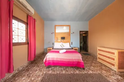 a bedroom with a bed and a large mirror at L'homme Du Désert A Merzouga in Merzouga