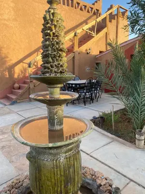 a fountain in the middle of a patio at Dar Talmoudi ,Traditional Riad, Local Food, Camel , Desert Excursions in Tagounite