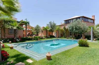 a swimming pool in the yard of a house at Villa du Cedre in Marrakech