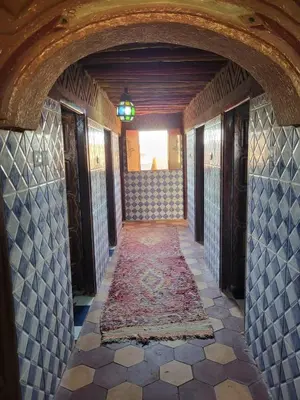 a hallway in a house with a tile floor at Desert Bivouac Mhamid in Mhamid