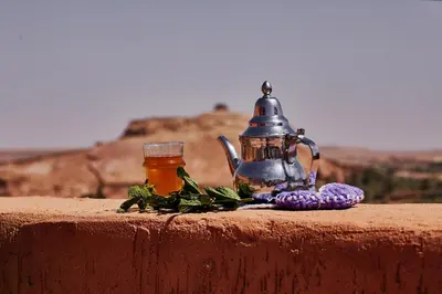 a tea kettle and a jar of honey on a wall at Riad Caravane in Aït Ben Haddou