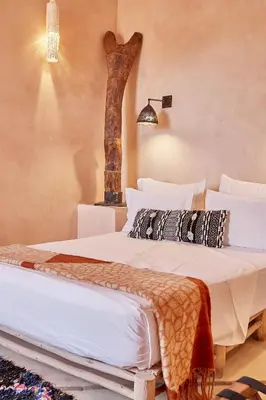 a bedroom with two beds in a room at Riad Caravane in Aït Ben Haddou