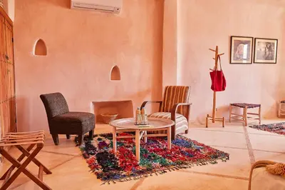 a living room with a table and chairs at Riad Caravane in Aït Ben Haddou
