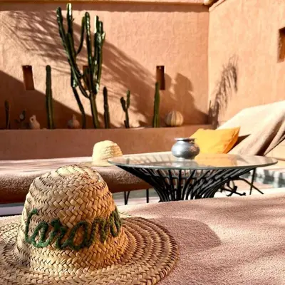 a straw hat sitting on top of a table at Riad Caravane in Aït Ben Haddou