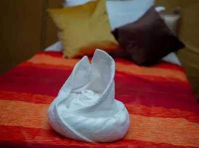 a pair of white shoes sitting on a bed at Luxury Desert Queen Camp in Merzouga