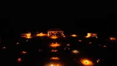 a group of lights in a parking lot at night at Luxury Desert Queen Camp in Merzouga