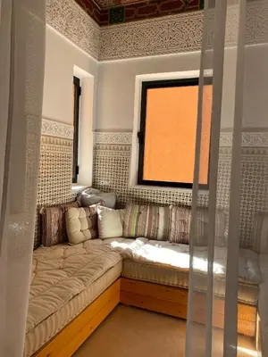 a living room with a couch and a window at Kasbah Tamsna in Ouarzazate