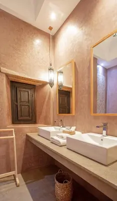 a bathroom with a sink and a mirror at Kasbah Tamsna in Ouarzazate