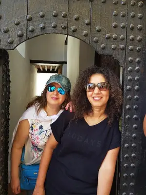 two women are standing in front of a mirror at Dar Ines in Moulay Idriss Zerhoun